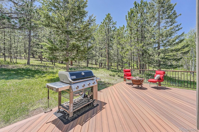 33 Sparrow Ct, Bailey, CO 80421 - deck with a fire pit, grilling area, a lawn, and view of wooded area