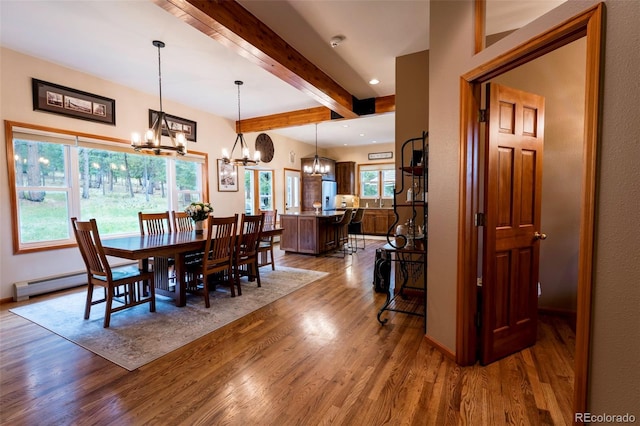 33 Sparrow Ct, Bailey, CO 80421 - dining space featuring a chandelier, wood finished floors, beam ceiling, a baseboard radiator, and recessed lighting