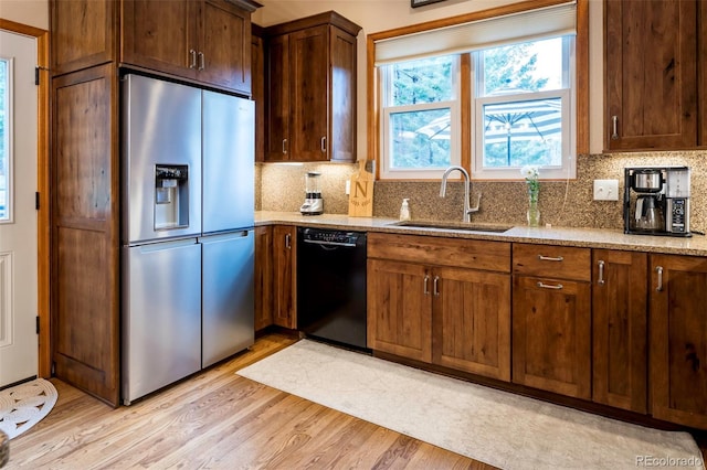 33 Sparrow Ct, Bailey, CO 80421 - kitchen with stainless steel fridge, black dishwasher, tasteful backsplash, and light stone counters