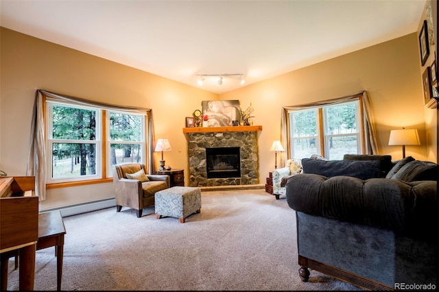33 Sparrow Ct, Bailey, CO 80421 - carpeted living area featuring baseboard heating, a stone fireplace, and rail lighting
