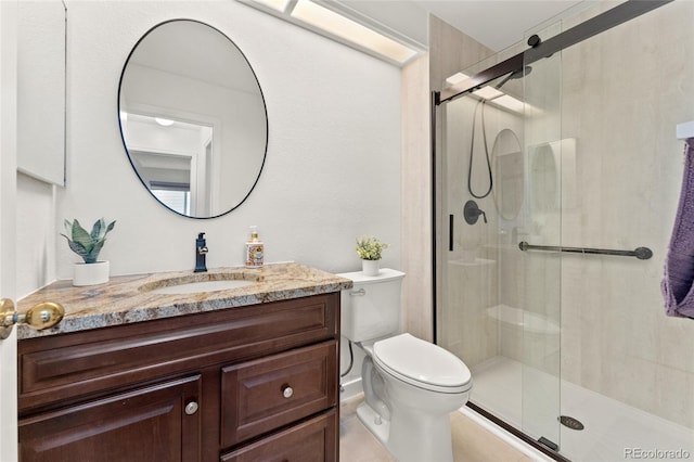 bathroom with walk in shower, vanity, and toilet