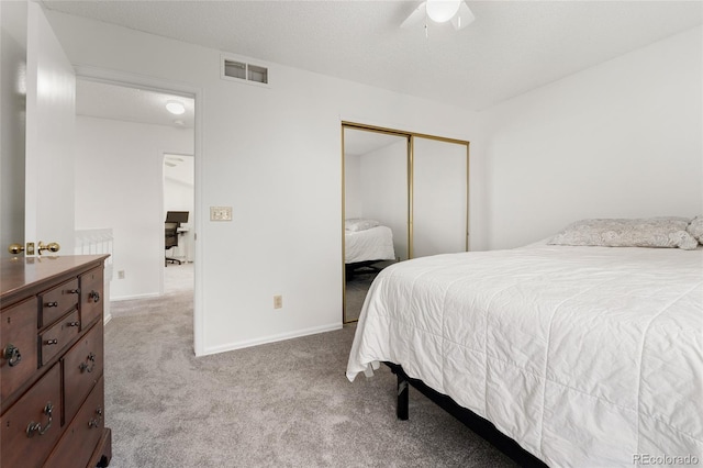 carpeted bedroom with ceiling fan, a textured ceiling, and a closet