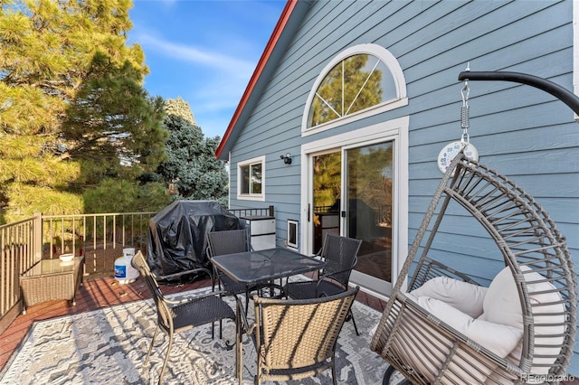 wooden terrace with a grill