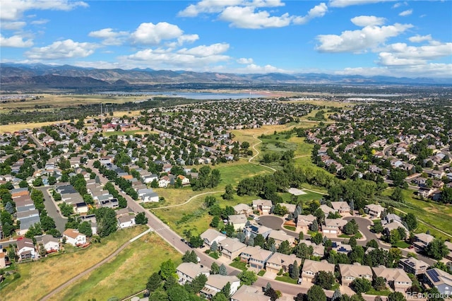 drone / aerial view featuring a water and mountain view