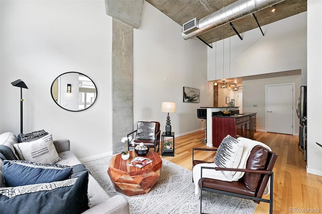 2518 16th St, Denver, CO 80211 - living area featuring light wood finished floors, baseboards, and a towering ceiling
