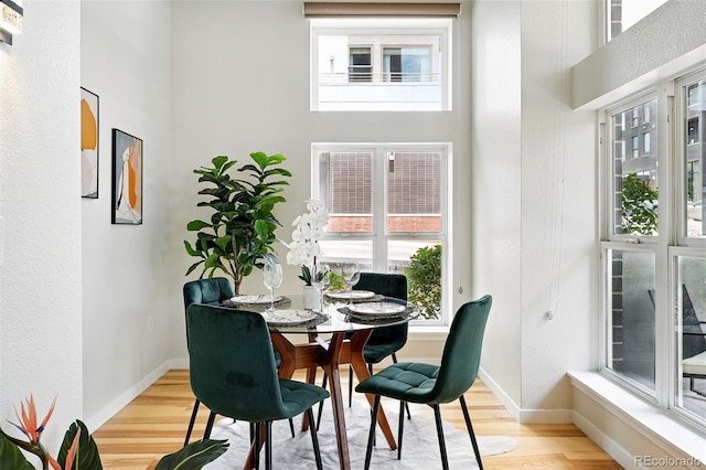 2518 16th St, Denver, CO 80211 - dining room featuring wood finished floors, a high ceiling, and baseboards