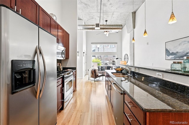 2518 16th St, Denver, CO 80211 - kitchen with stainless steel appliances, a sink, light wood-type flooring, decorative light fixtures, and a ceiling fan