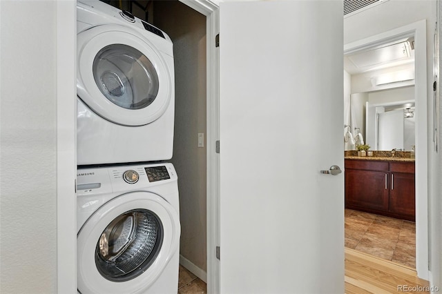 2518 16th St, Denver, CO 80211 - washroom with estacked washer and dryer and baseboards