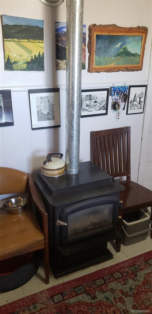 details featuring a wood stove and tile patterned floors