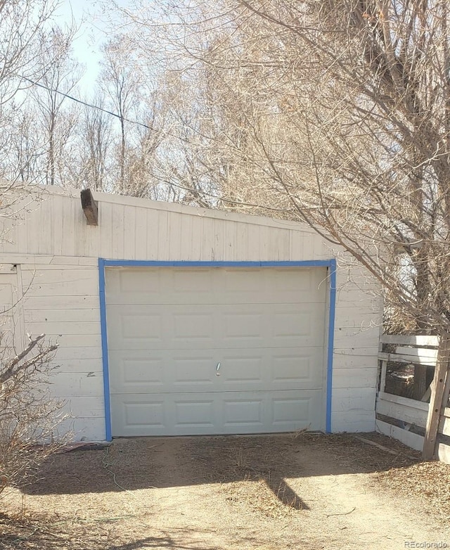 garage featuring wooden walls