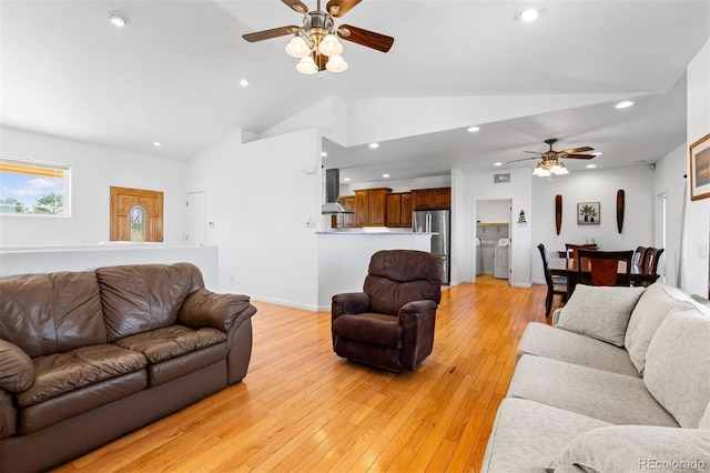 living room featuring ceiling fan, high vaulted ceiling, and light hardwood / wood-style floors