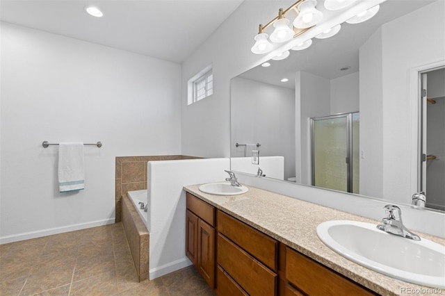 bathroom featuring vanity and independent shower and bath