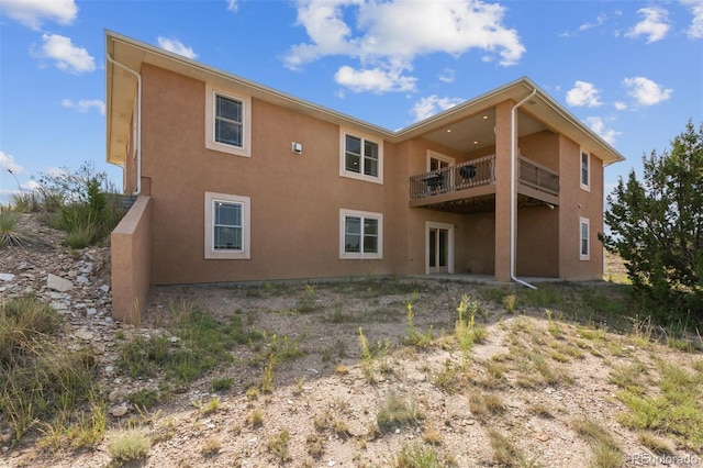 rear view of property with a balcony