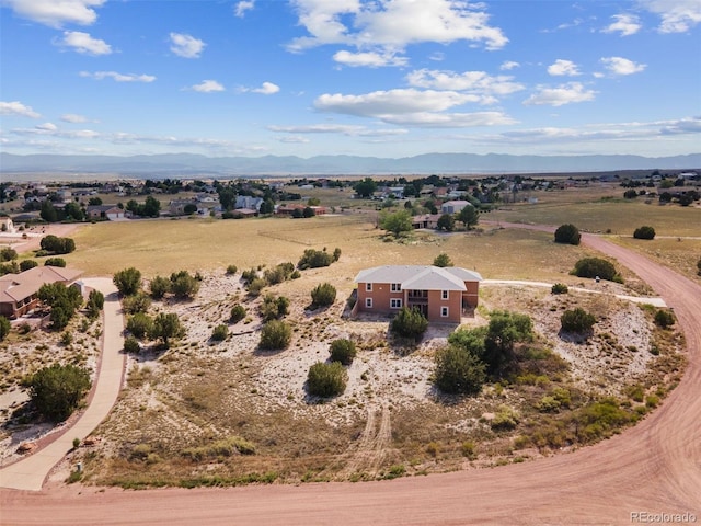 birds eye view of property featuring a mountain view and a rural view