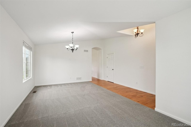 11847 Trail View Ln, Parker, CO 80134 - carpeted empty room with a chandelier and arched walkways