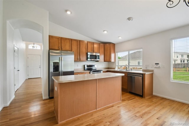 11847 Trail View Ln, Parker, CO 80134 - kitchen with stainless steel appliances, light countertops, a kitchen island, light wood-type flooring, and lofted ceiling