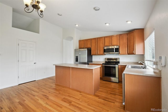 11847 Trail View Ln, Parker, CO 80134 - kitchen with stainless steel appliances, lofted ceiling, light wood-style floors, light countertops, and a center island