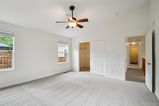 11847 Trail View Ln, Parker, CO 80134 - unfurnished bedroom featuring vaulted ceiling, carpet flooring, ceiling fan, a closet, and a walk in closet