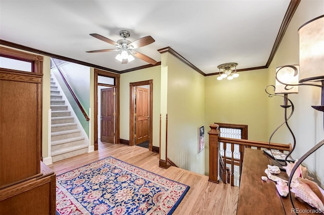 foyer featuring a notable chandelier, ornamental molding, and light wood-type flooring