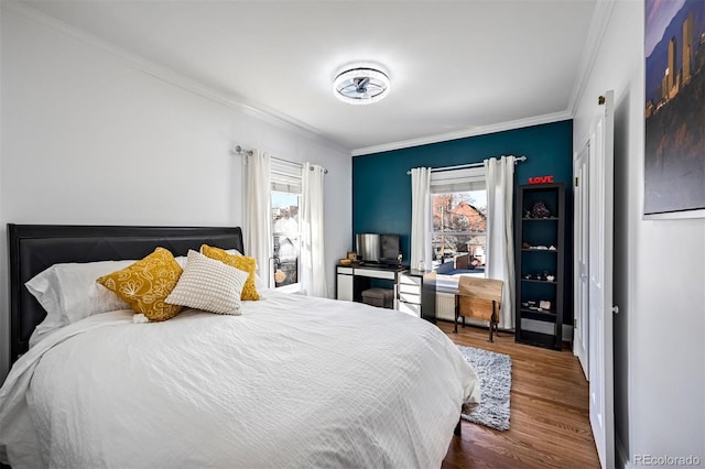 bedroom with hardwood / wood-style floors and crown molding