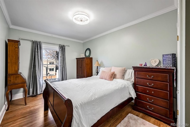 bedroom featuring ornamental molding and dark hardwood / wood-style floors