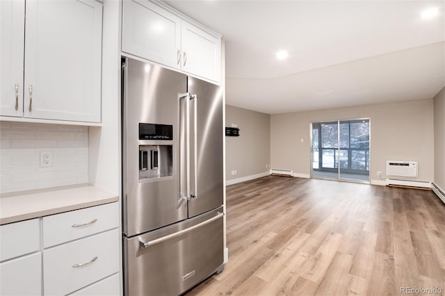 kitchen featuring white cabinetry, baseboard heating, backsplash, light hardwood / wood-style floors, and high quality fridge