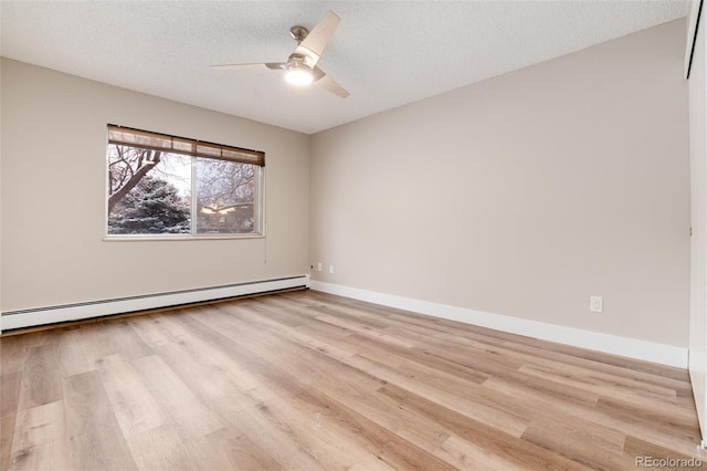 empty room featuring a textured ceiling, light hardwood / wood-style flooring, ceiling fan, and a baseboard heating unit