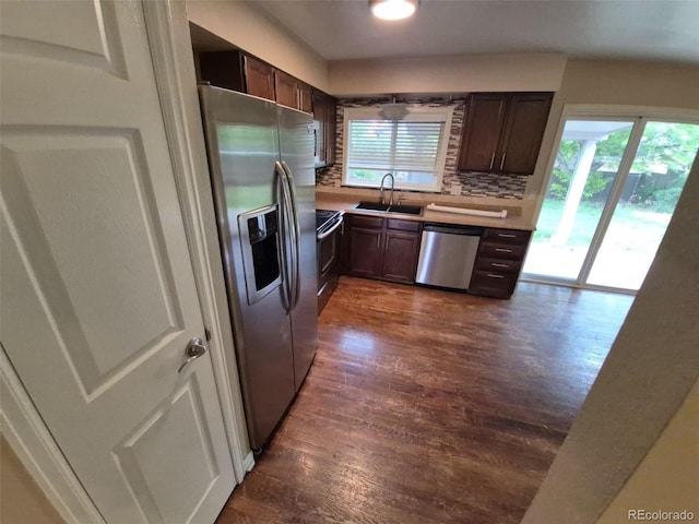 1962 S Ivory Way, Aurora, CO 80013 - kitchen with stainless steel appliances, dark wood-style floors, a sink, tasteful backsplash, and dark brown cabinetry