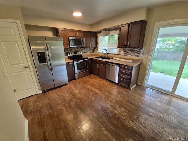 1962 S Ivory Way, Aurora, CO 80013 - kitchen featuring appliances with stainless steel finishes, a sink, dark wood-type flooring, light countertops, and decorative backsplash