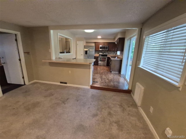 1962 S Ivory Way, Aurora, CO 80013 - kitchen featuring appliances with stainless steel finishes, baseboards, light countertops, dark brown cabinetry, and a textured ceiling