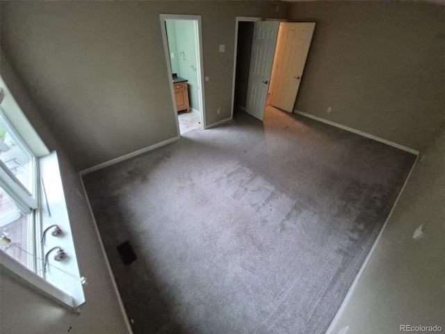 1962 S Ivory Way, Aurora, CO 80013 - unfurnished bedroom with baseboards, light colored carpet, and ensuite bath