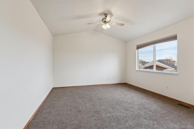 empty room with baseboards, lofted ceiling, carpet floors, and a ceiling fan