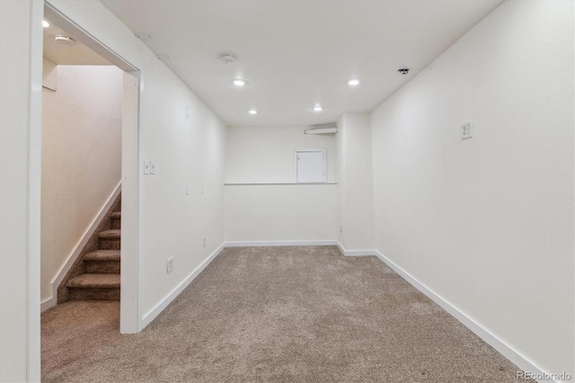 below grade area featuring carpet floors, baseboards, stairs, and recessed lighting