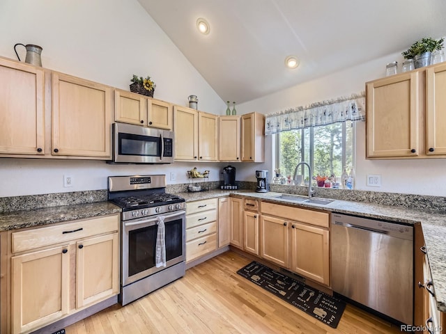 11526 Green Cir, Conifer, CO 80433 - kitchen with stainless steel appliances, light brown cabinetry, lofted ceiling, light wood-type flooring, and recessed lighting