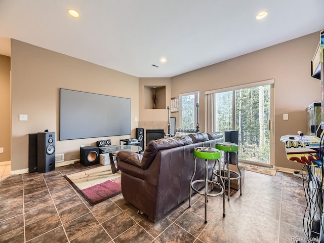 11526 Green Cir, Conifer, CO 80433 - home theater room featuring a tiled fireplace and recessed lighting