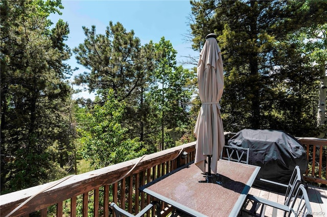 11526 Green Cir, Conifer, CO 80433 - wooden terrace featuring outdoor dining area and area for grilling