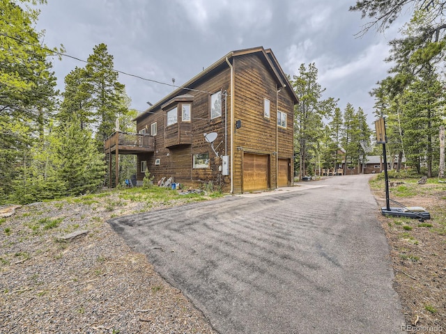 11526 Green Cir, Conifer, CO 80433 - view of side of home featuring a garage and asphalt driveway
