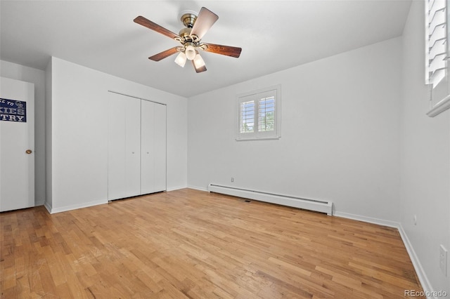 888 E Davies Ave, Centennial, CO 80122 - unfurnished bedroom featuring a baseboard heating unit, light wood-style floors, a closet, and ceiling fan