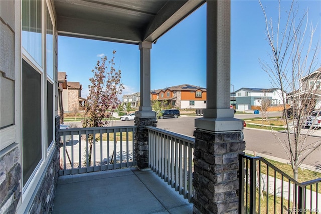balcony featuring a porch and a residential view