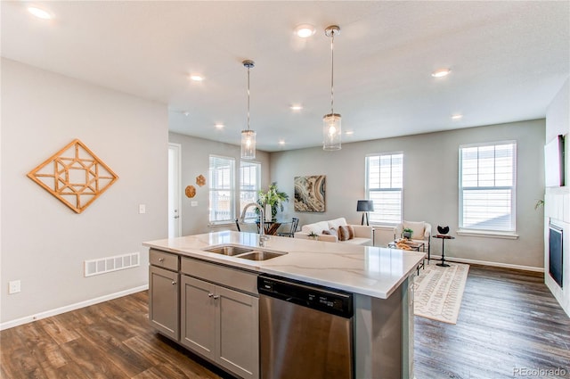 kitchen with dark wood-style flooring, visible vents, dishwasher, a sink, and gray cabinetry
