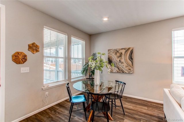 dining space featuring baseboards and dark wood finished floors