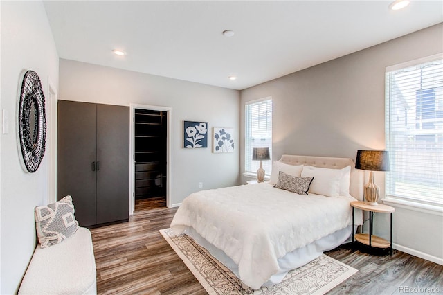 bedroom with baseboards, recessed lighting, and wood finished floors