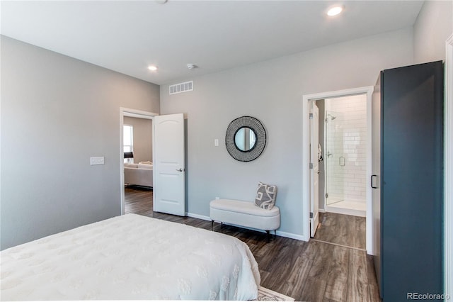 bedroom with dark wood-style flooring, visible vents, baseboards, connected bathroom, and recessed lighting