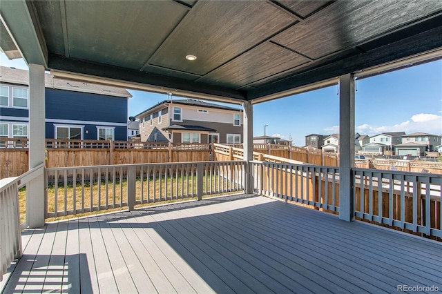 deck featuring a fenced backyard and a residential view
