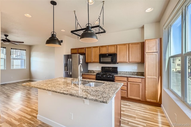 kitchen with a wealth of natural light, sink, and black appliances