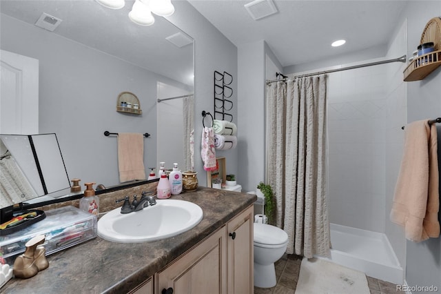 bathroom with vanity, a shower with shower curtain, and toilet