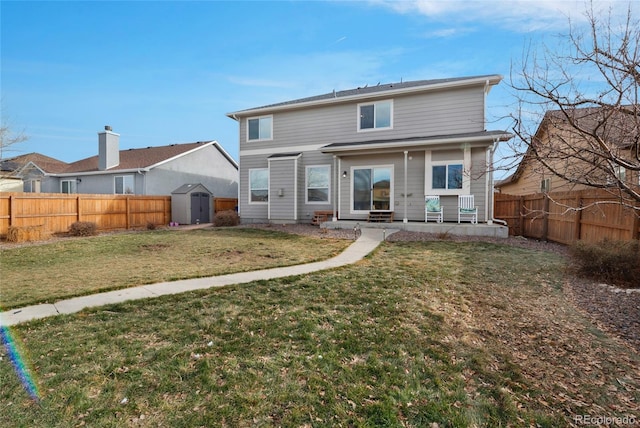 rear view of house with a yard and a storage unit