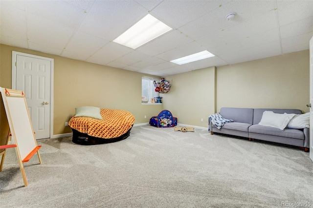 playroom featuring carpet and a paneled ceiling