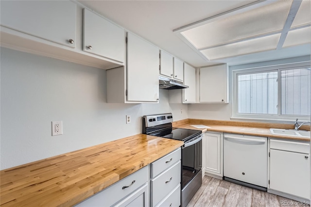 kitchen with white cabinets, white dishwasher, under cabinet range hood, stainless steel range with electric stovetop, and a sink