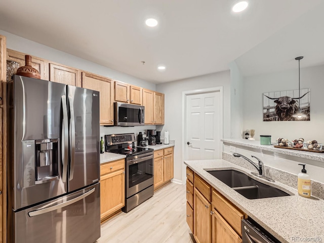 5755 N Genoa Way Unit 14-105, Aurora, CO 80019 - kitchen with stainless steel appliances, light wood-style flooring, light stone countertops, light brown cabinets, and recessed lighting